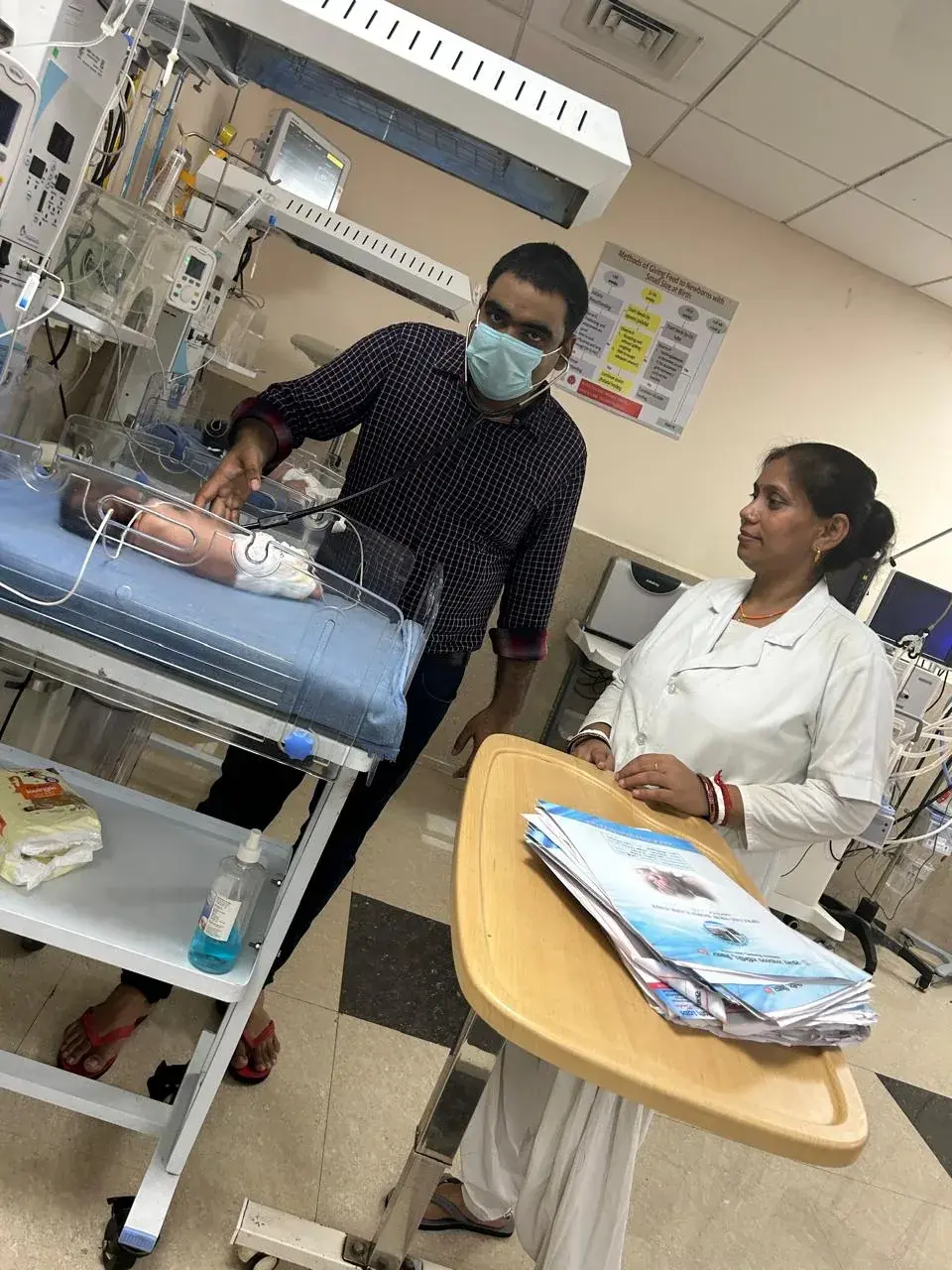 Dr. Jha and nursing staff with a newborn incubator
