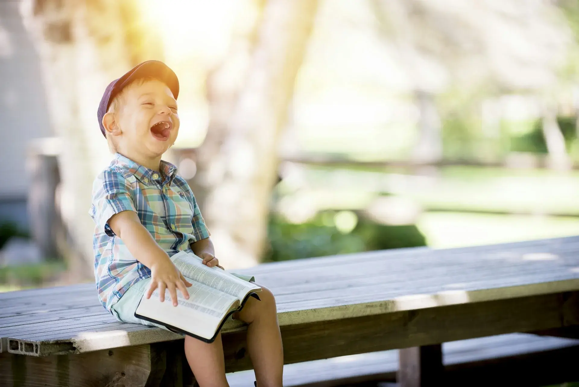 A laughing child outdoors in the sun